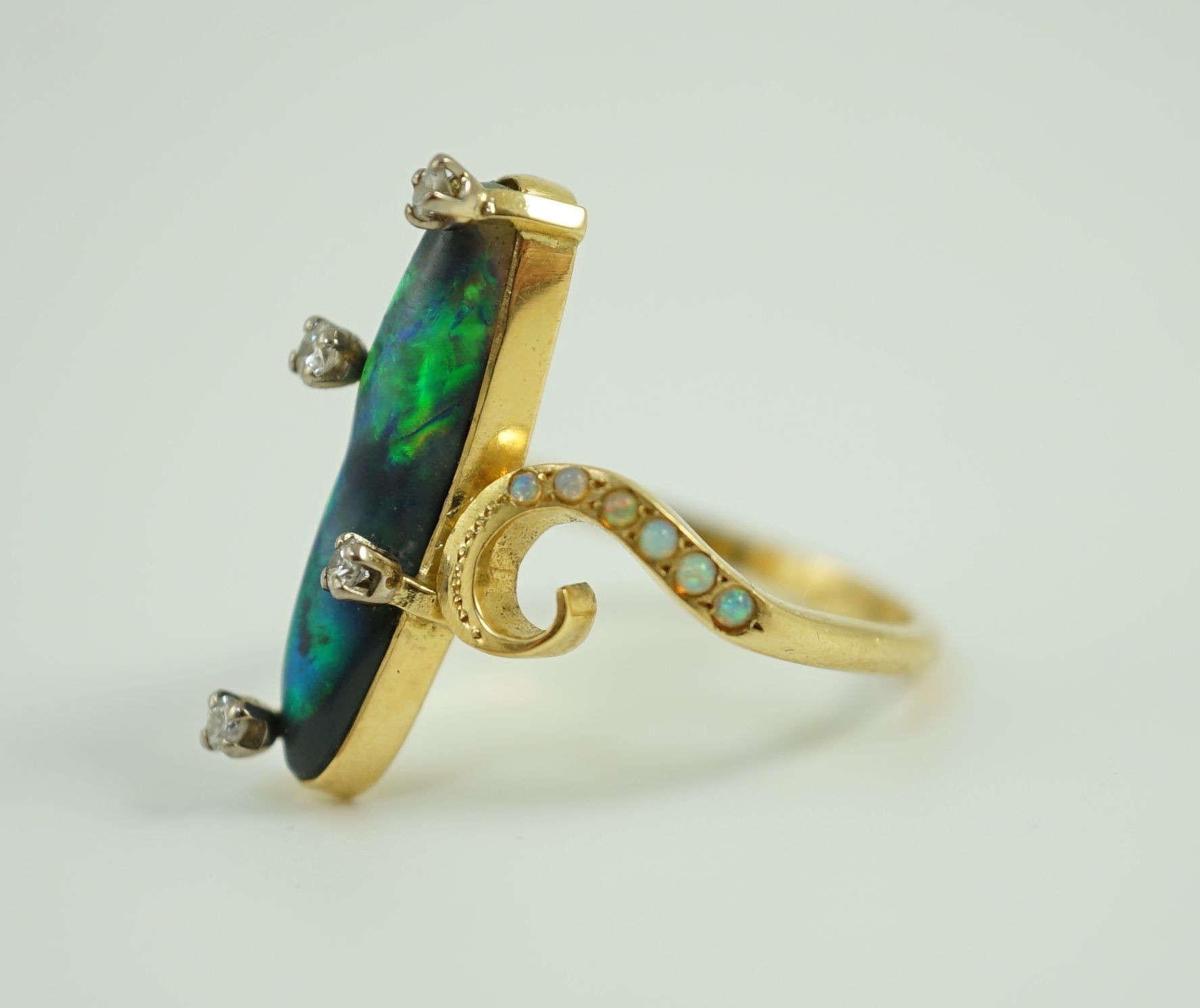 A stylish early to mid 20th century 18ct gold, black opal and diamond chip set dress ring